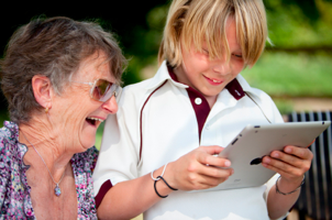 Grandmother with child on iPad