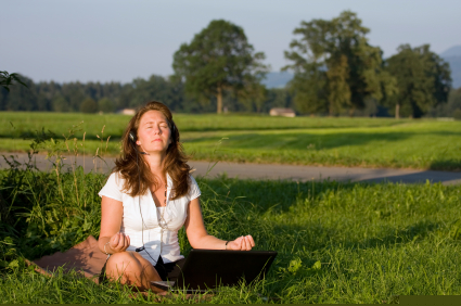 Woman in meadow with computer