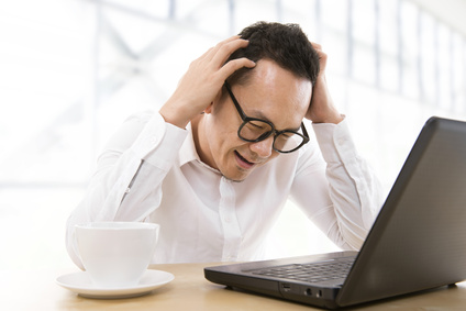 Man looking confused by his computer