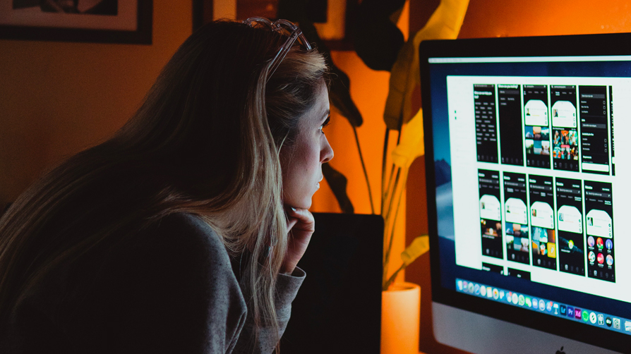 woman staring intently at her computer screen