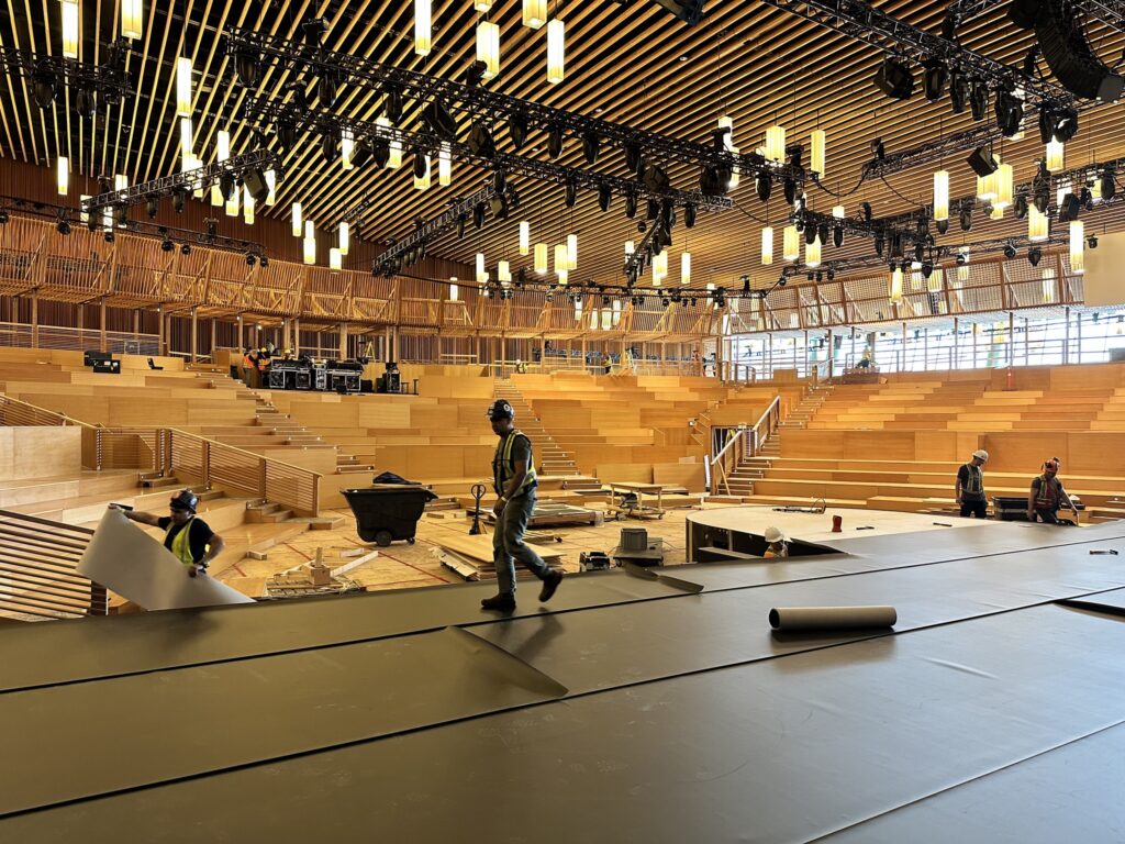 TED theater under construction: wood amphitheater with construction workers