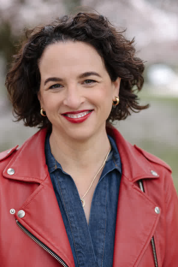 headshot_blueshirt smiling woman in red leather jacket